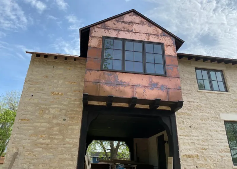 Copper metal panel facade on a stone building for Skylight Installation in Dacula