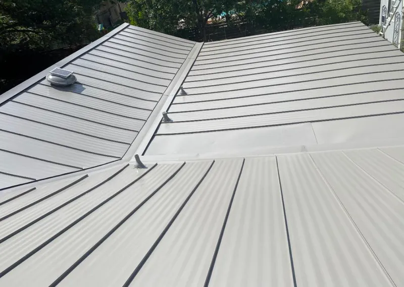 Solar attic fan installed on a metal roof for Roof Ventilation in Dacula